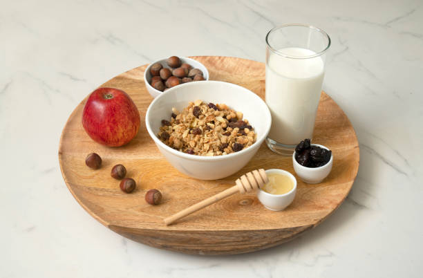 istock Healthy breakfast, honey, prunes, muesli, nuts, milk. 1320273437
