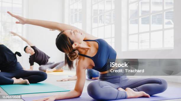 Young Asian Sporty Attractive People Practicing Yoga Lesson With Instructor Asia Group Of Women Exercising Healthy Lifestyle In Fitness Studio Stock Photo - Download Image Now