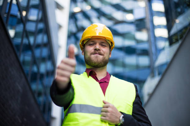 istock Smiling engineer standing on the street. Cloe up. Thumb up. 1320274738