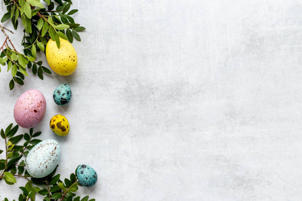 istock Frame of Easter eggs with spring branches and green leaves. Veiw from above 1320274845