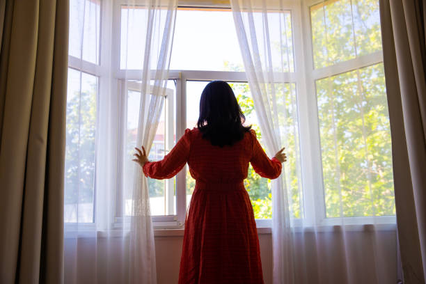 istock Opening curtain in the morning 1320274950