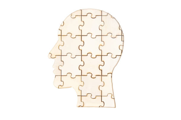 istock Man's head silhouette made from wooden puzzle pieces isolated on white 1320275871