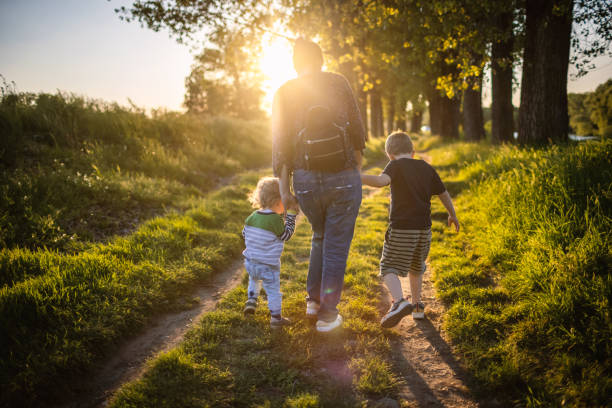 istock Mother and boys in nature 1320276722