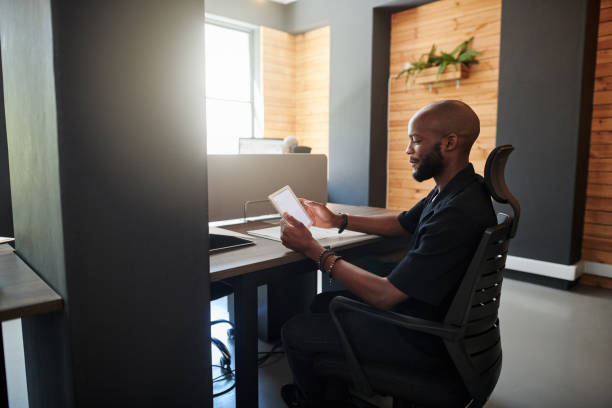 istock Shot of a young businessman using a digital tablet in an office 1320277008