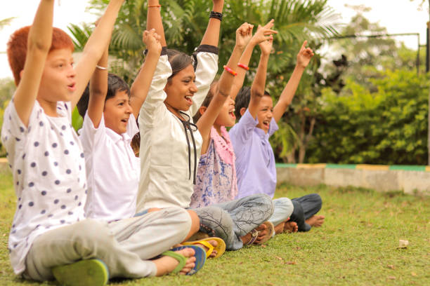 istock Side view, Group of young children cheering up at park - teens having fun during summer camp vacation - Multi ethnicity children playing joyful by braking the racism. 1320278030