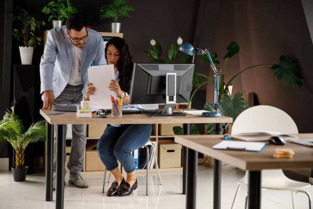 istock Businessman reviewing project paperwork with his assistant 1320278306