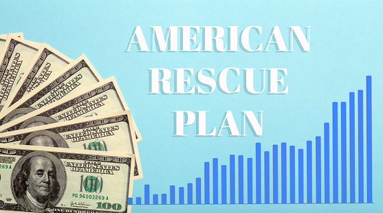 USA dollars background. American rescue plan, USA relief program, stimulus check and Act of 2021 concept. Money, business, profit and livelihood idea. High quality photo
