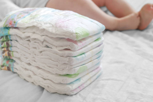 Stack of diapers on a white bed Stack of diapers on a white bed adult diaper stock pictures, royalty-free photos & images