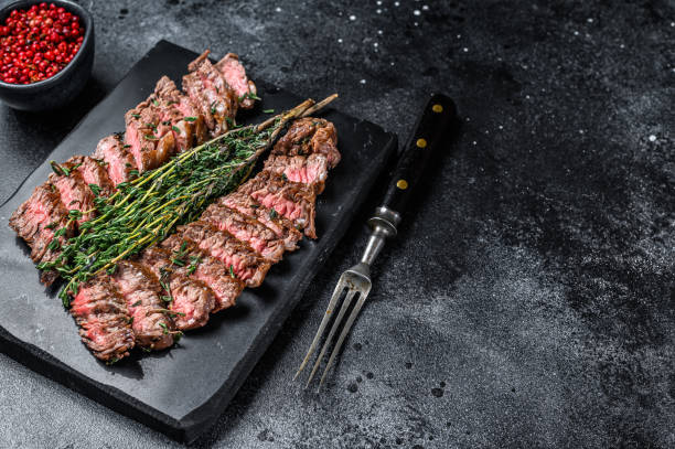 istock Skirt machete grilled  meat beef Steak. Black background. Top view. Copy space 1320279432