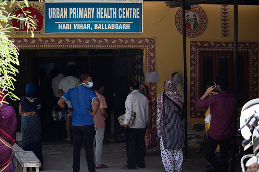 Faridabad Haryana India 24 May 2021 - Group Of People In Mask Standing At PHC Primary Health Care Center To Get Vaccinated For Novel Coronavirus nCovid-19, COVID-19, nCOV 2019 disease from Wuhan