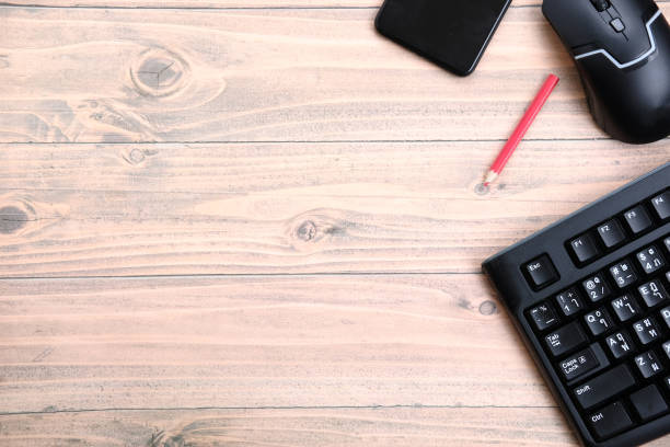 istock Keyboard on wood table background and top view working space 1320288088