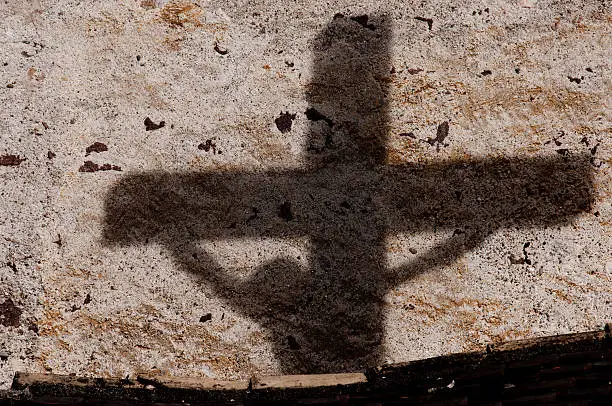 Shadow on the wall of Jesus on the cross