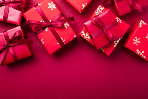 istock Christmas red paper covered gift boxes layout, overhead view 1320290764