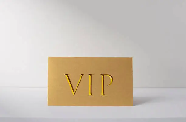 Photo of Golden VIP card on white desk, ID card for VIP persons, business concept picture