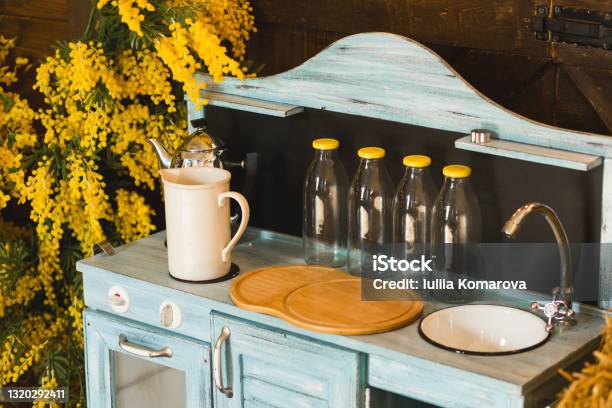 Cozy Rustic Wooden Kitchen With Crockery And Yellow Flowers Stock Photo - Download Image Now