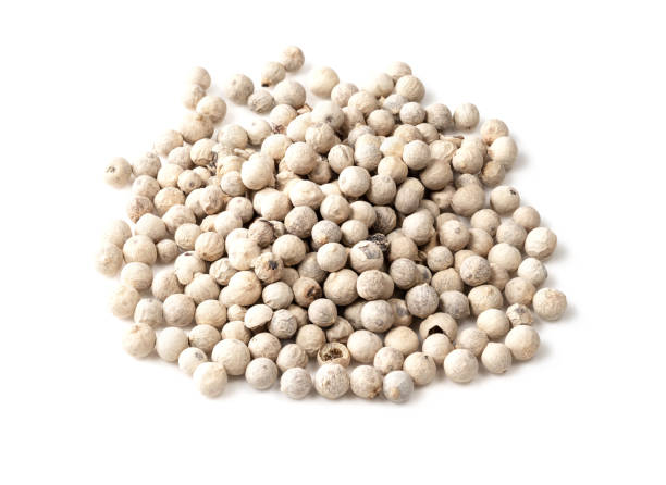 istock handful of white pepper peppercorns on white 1320293992