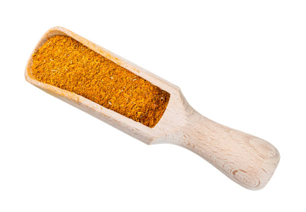 ground Dried Marigold Flowers in wood scoop cutout top view of ground Imeretian Saffron (Dried Marigold Flowers) in wood scoop cutout on white background substitute for saffron stock pictures, royalty-free photos & images