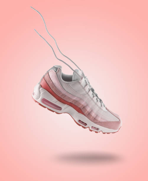 woman pink sneaker on a light pink gradient background, woman's fashion, sport shoe, sneakers concept, lifestyle - nike imagens e fotografias de stock