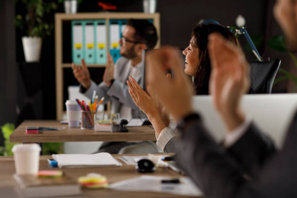 istock Coworkers applauding after successfully concluding a meeting 1320295596