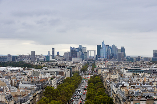Paris, France, September 30, 2017: View from the Arc de Triomphe of the Paris skyline on the boulevards that Baron Haussmann had built in the mid-19th century with the financial center in the background.