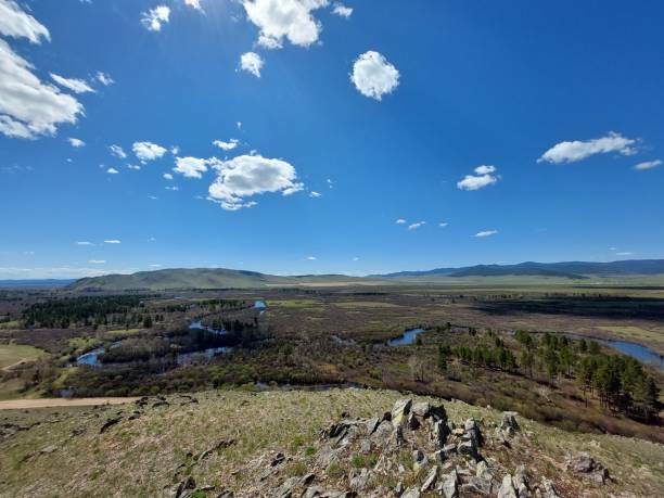 istock River flowing crossing valley and forest Aerial view under Blue Sky reflecting in Water Surface and mountains ridge on horizon 1320295699