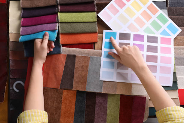 istock Woman choosing among colorful fabric samples, closeup 1320295794