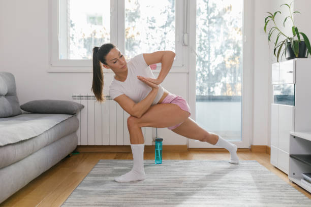 istock Fit young woman stretching and practicing yoga at home 1320295863