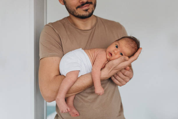 istock Father Bonding With Newborn In Diaper 1320296496