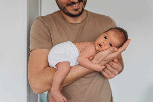 istock Father Bonding With Newborn In Diaper 1320296499