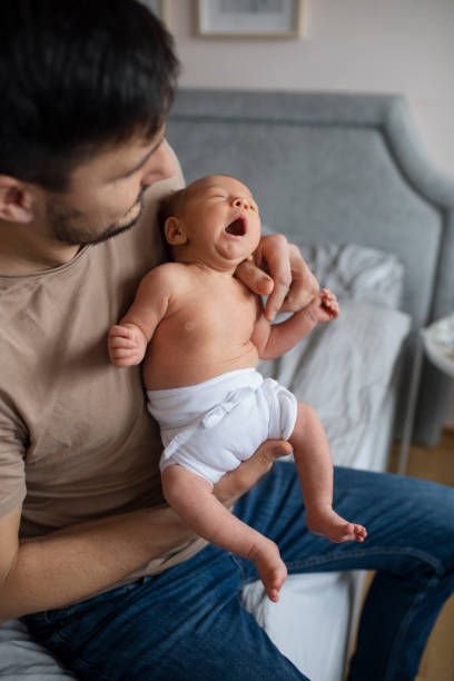 istock Unrecognizable Father Bonding With Crying Newborn 1320296518