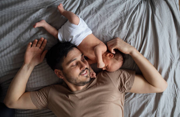 istock Happy Father Bonding With Newborn In Diaper 1320296524