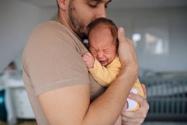 istock Father Bonding With Newborn In Yellow Sleepsuits 1320296528