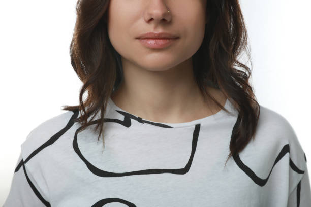 istock Young woman with nose piercing on white background, closeup 1320296560