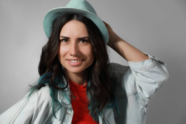 istock Beautiful young woman with nose piercing on grey background 1320297127