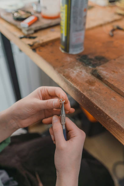 istock Woman making jewelry at her studio 1320297877