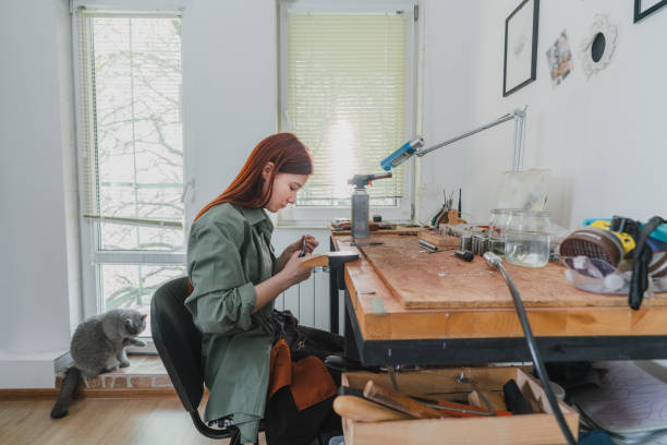 istock Woman making jewelry at her studio 1320297879