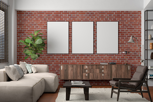Three vertical blank poster mockup on red brick wall in interior of living room. 3d illustration