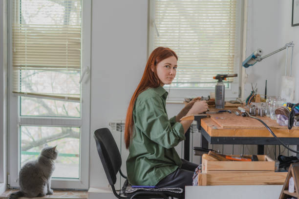 Woman making jewelry at her studio at home