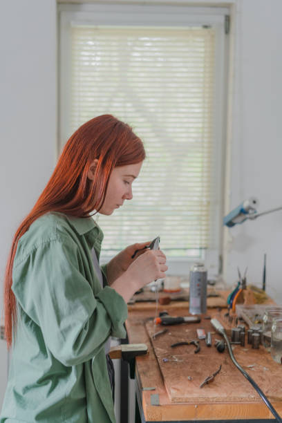 istock Woman making jewelry at her studio 1320298023