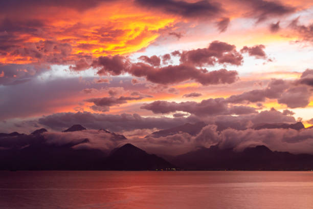 Beautiful bright sunset on mountains with storm clouds stock photo
