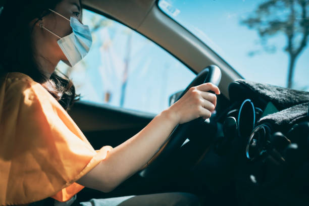 istock Driving car with face mask 1320299463
