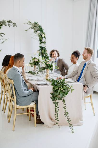 istock Guests at the wedding sitting at table and talking 1320299547