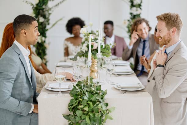 istock Newlyweds having fun with their friends at the wedding reception 1320299578