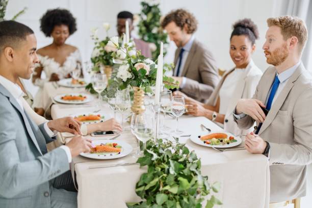 istock Newlyweds having fun with their friends at the wedding reception 1320299620