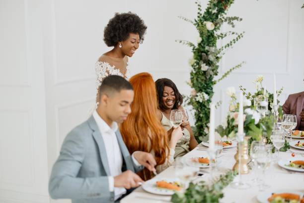istock Newlyweds having fun with their friends at the wedding reception 1320299633
