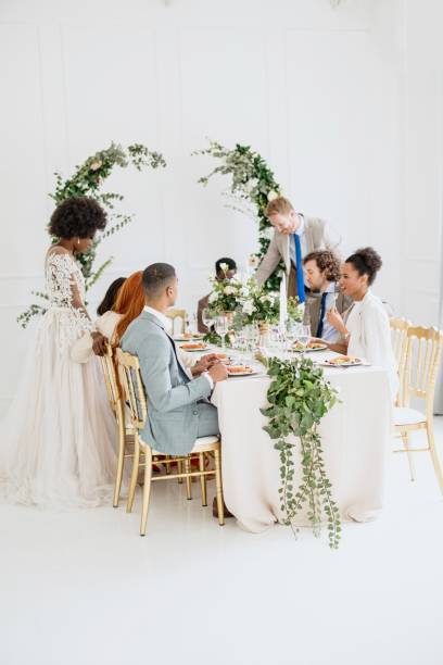 istock Newlyweds having fun with their friends at the wedding reception 1320299665