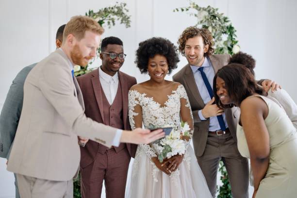 istock Newlyweds watching video messages from friends how couldn't come due Covid-19 1320301093