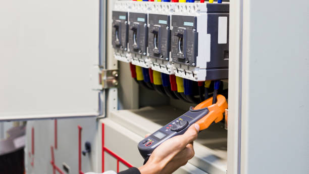 istock Electrician engineer work tester measuring voltage and current of power electric line in electical cabinet control. 1320301151