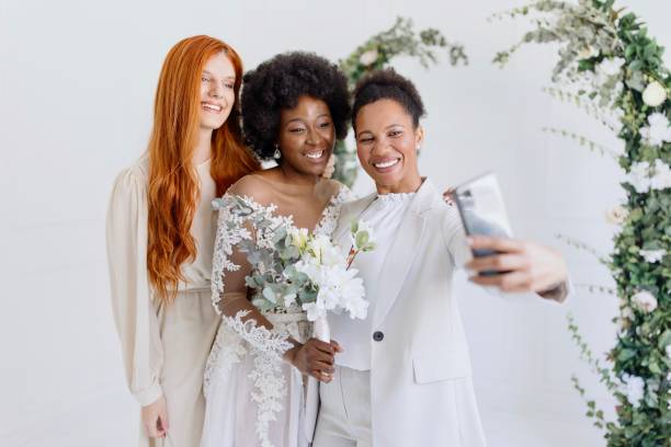 istock Bridesmaids taking selfie with bride 1320301221