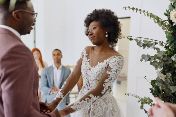 istock Bride and groom exchanging wedding vows 1320301273